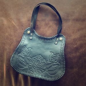 Hand tooled handmade leather handbag.